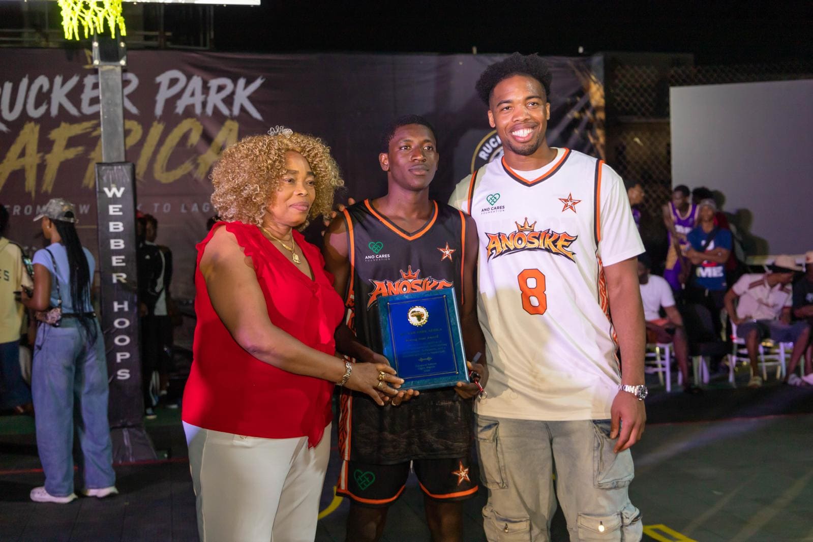 Damilare Salawu receiving the U-18 MVP award from E.J. Anosike and Mrs. Ngozi Anosike